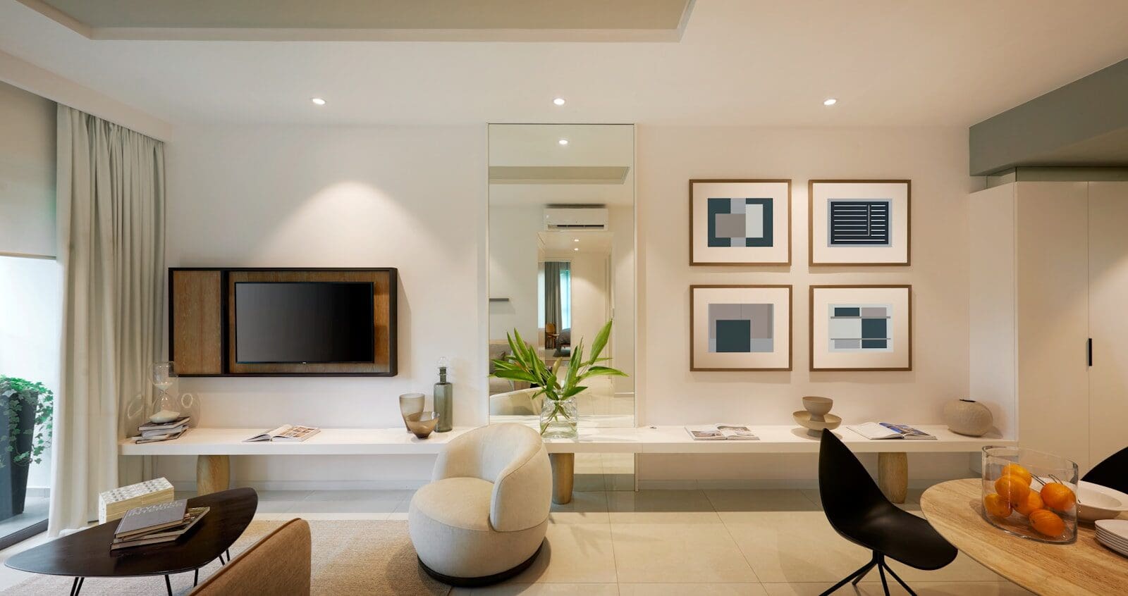 A modern living room with a television, armchair, and framed abstract art